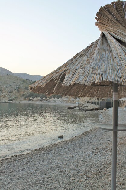 Sea beach with thatched umbrellas without people