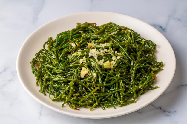 Sea beans and green meze on table. Turkish name; Deniz borulcesi mezesi