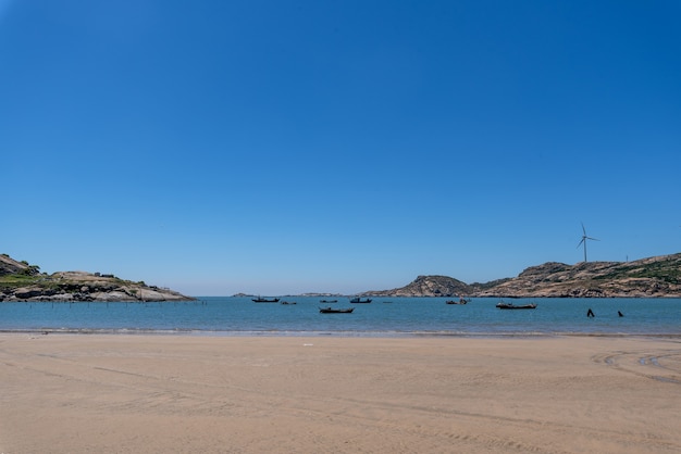 The sea under the blue sky, clean beaches and sea water, as well as islands and windmills