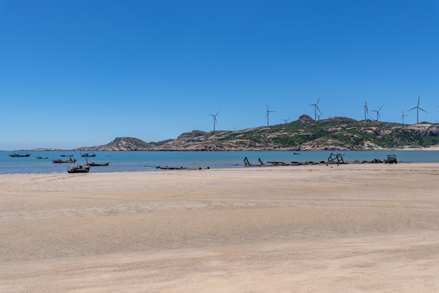 The sea under the blue sky, clean beaches and sea water, as well as islands and windmills