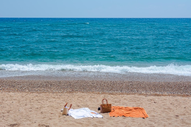 Sea deserted beach beach bags and towels are spread out right on the sand