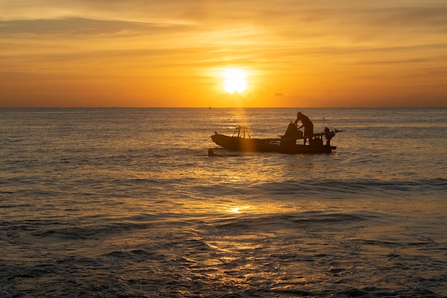 Sea fishing boat boat at sunset