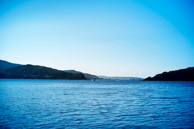 Sea landscape hills horizon sky fog nature saturated.