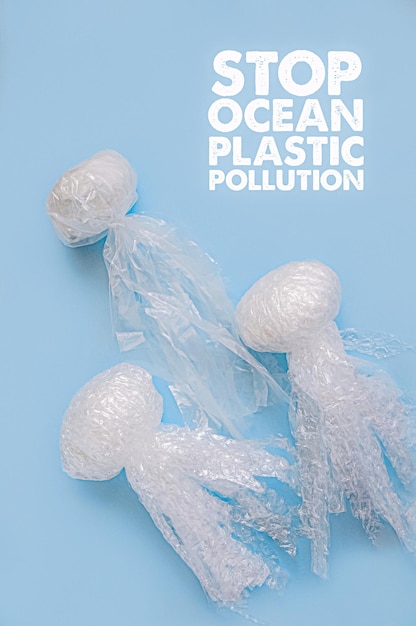 Photo sea and ocean life from waste jellyfishes out of plastic waste on blue background pollution of the planet concept of saving the environment oceans seas and rivers