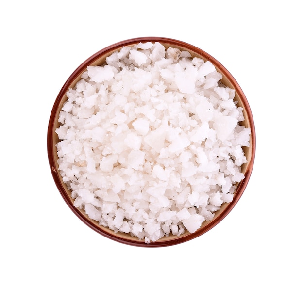 Sea salt in bowl on white surface