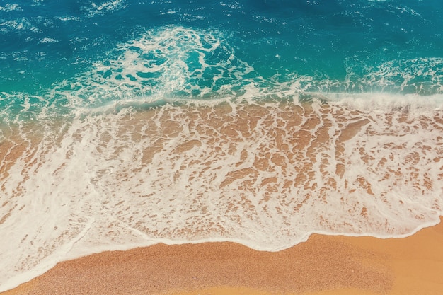 Sea sandy beach and  wave of blue ocean. Natural holiday background.