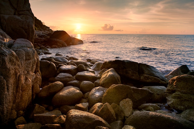 sea scape sun rising sky on abandoned rock beach