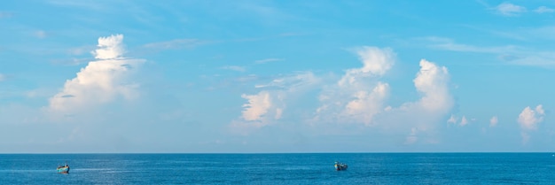 Sea sky cumulus cloud landscape view background Calm water alone fishing boat Destination aim progress concept