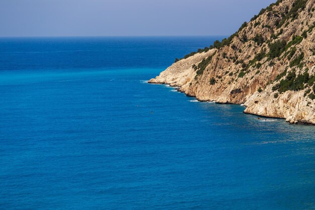 Sea and sky landscape with the horizon and a separate side ledge of the mountain or hill