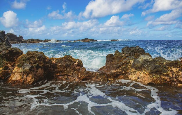 Sea stone beach sea waves colorful blue sea background the concept of summer vacation and travel cle