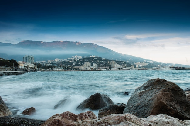 Sea stones and mountains at sunset