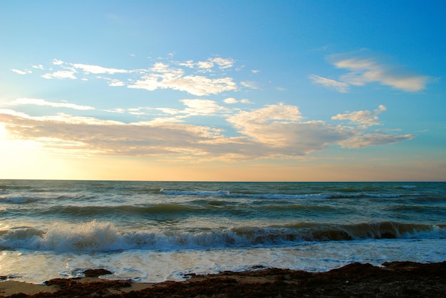 Sea sunset waves and blue sky