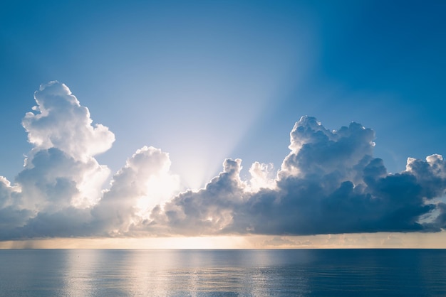 Sea sunset with sky and sun through the clouds over ocean and sky background seascape