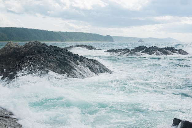 Sea surf among the cliffs overlooking the distant shore