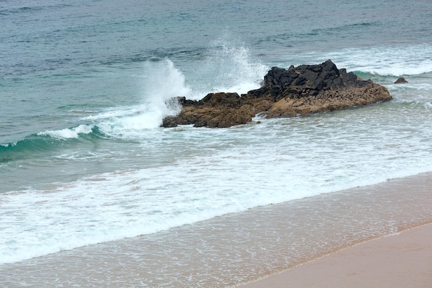 Sea surf waves and sandy beach. View from above.