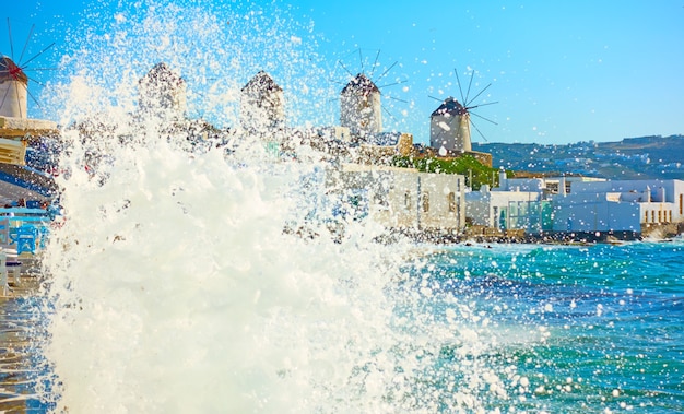 Sea surf and windmillls on the coast of Aegean Sea in Mykonos, Cyclades, Greece