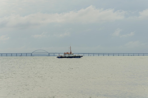 A sea tug on the background of the Crimean bridge.