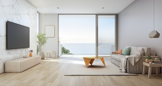 Sea view living room of luxury beach house with glass door and wooden terrace.