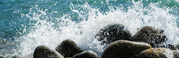 Sea water hits rocks on the beach By the sea with strong waves