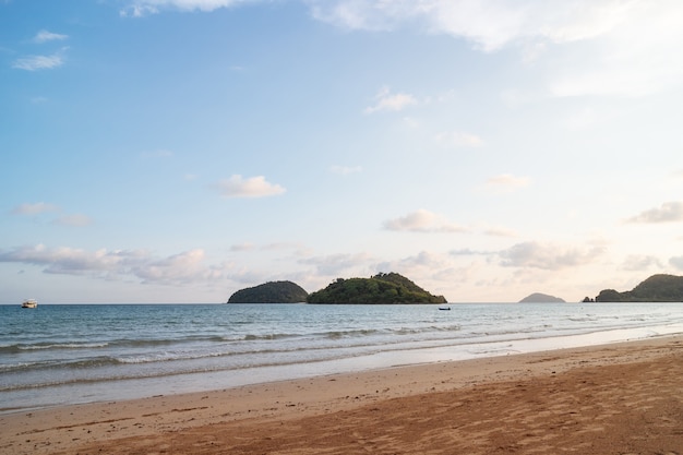 Sea wave moving to the beach with green islands and blue