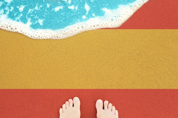 Sea wave on the sunny sandy beach with flag Spain View from top on surf