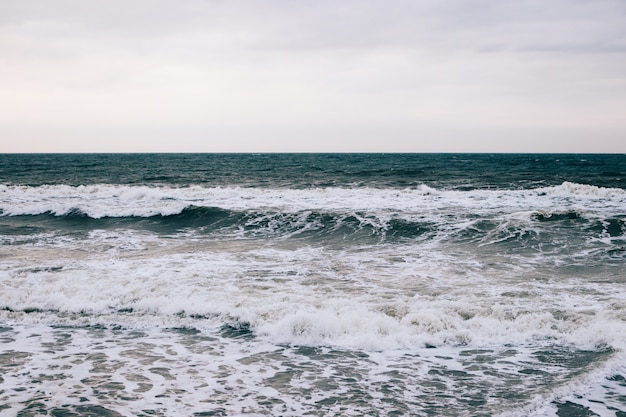 Sea and the waves in winter at dawn