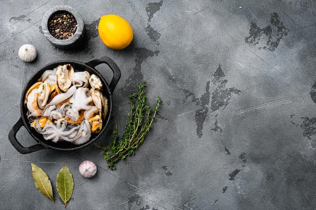 Seafood board with shrimp, squid mussel and octopus set, on gray stone table background, top view flat lay, with copy space for text