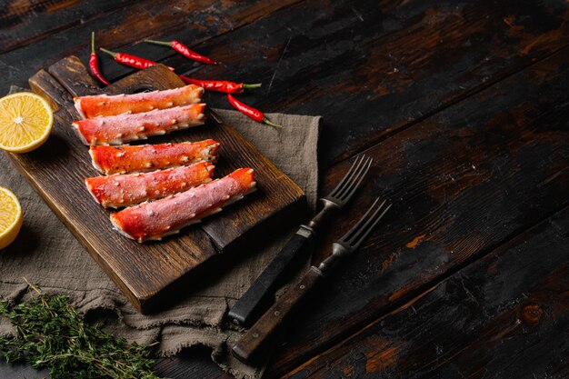 Seafood Crab Legs set on old dark wooden table background with copy space for text