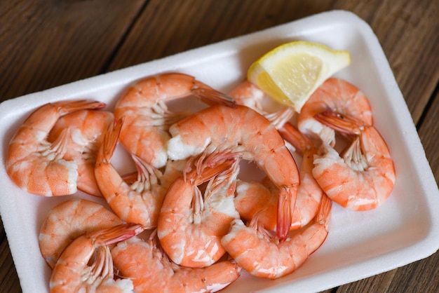 Seafood fresh shrimps on on plate plastic tray with lemon boiled shrimp prawns cooked food order food to go home takeaway restaurants food delivery concept