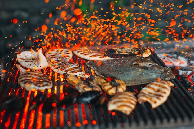 Seafood on the grill, Mussels, shrimp, squid and fish are cooked on fire.