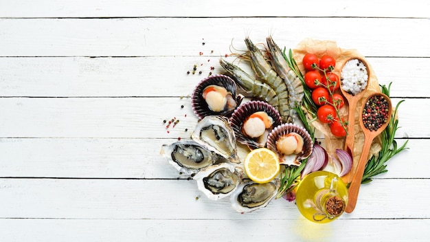 Seafood Oysters scallops shrimp Top view On a white wooden background Free copy space