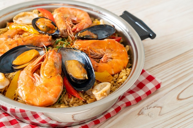 Seafood Paella with prawns clams mussels on saffron rice