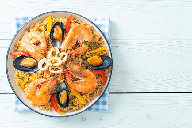 Seafood Paella with prawns clams mussels on saffron rice