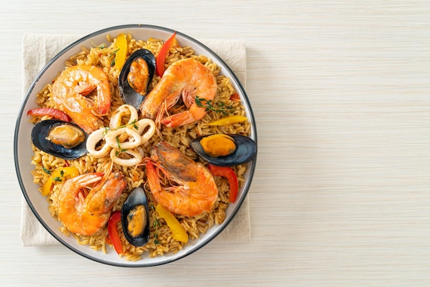 Seafood Paella with prawns clams mussels on saffron rice