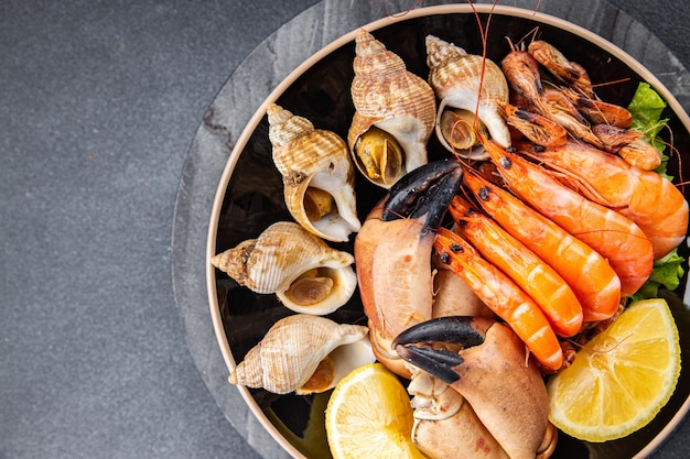 seafood plate shrimp crab claw clam rapan trumpeter mollusk meal food snack on the table