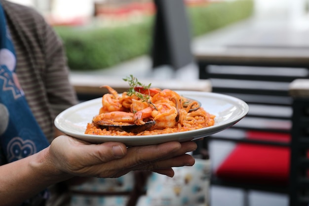 Seafood risotto with mussel shrimp and squid , italian food with hand