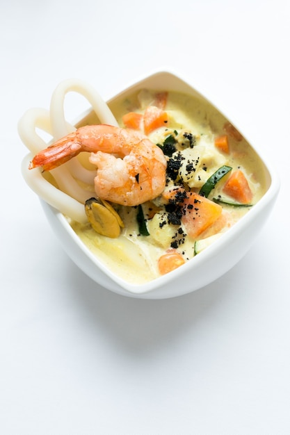 Seafood soup on a white surface