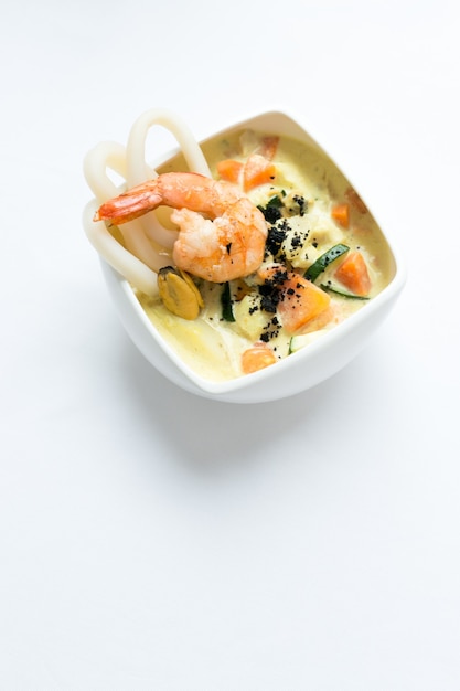 Seafood soup on a white surface