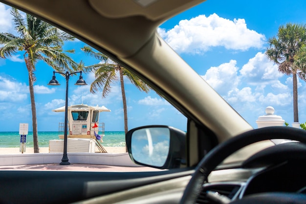 Seafront beach promenade with palm trees on background on sunny day in Fort Lauderdale in Florida USA view from a car