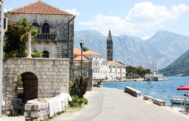 The seafront of Tivat with views of the chapel and mountains