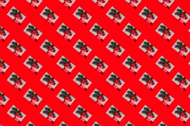 Seamless minimalistic pattern of Christmas gifts on a red background Photo collage Christmas background wallpaper