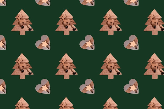 Seamless minimalistic pattern of Christmas wooden toys on a green background Photo collage Christmas background wallpaper