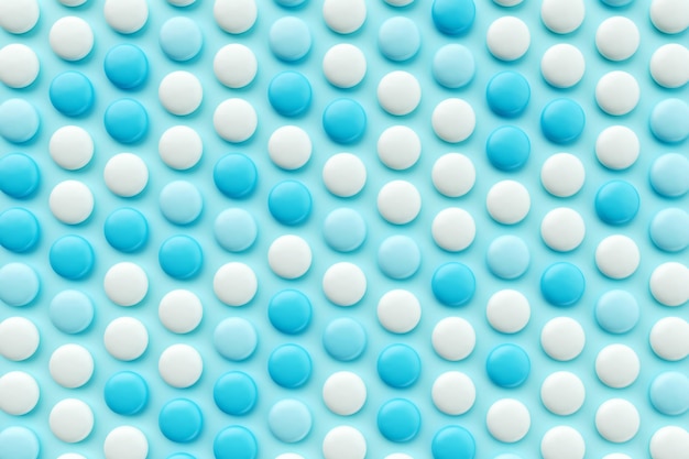 Seamless pattern of Chocolate candy coated in blue and white Background 3d illustration