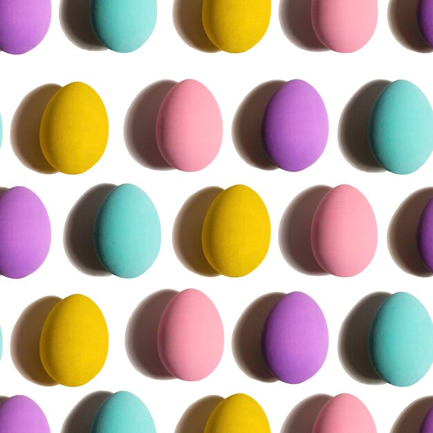 Seamless Pattern made of chicken eggs on white background Minimal food concept Happy easter bluepink purple yellow chicken egg