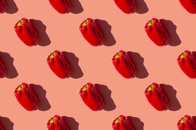 Photo seamless pattern of a photo of a ripe red bulgarian pepper on a pink background