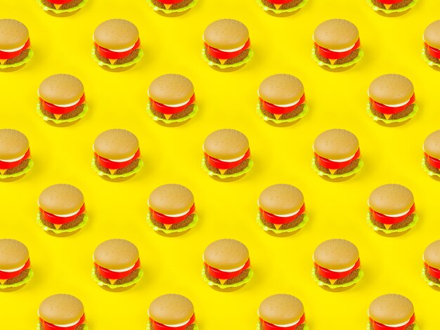 Seamless pattern of plastic hamburger on a yellow background.