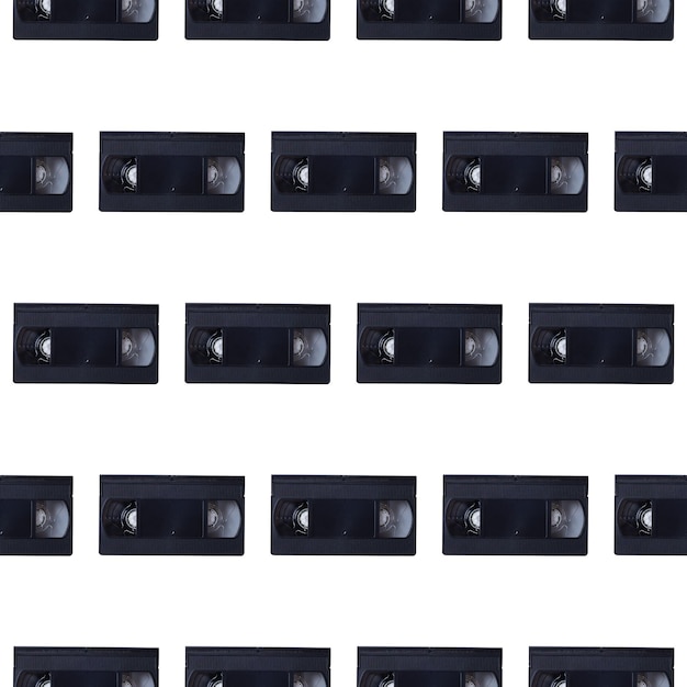 Seamless pattern of video cassettes on a white background Retro gadgets