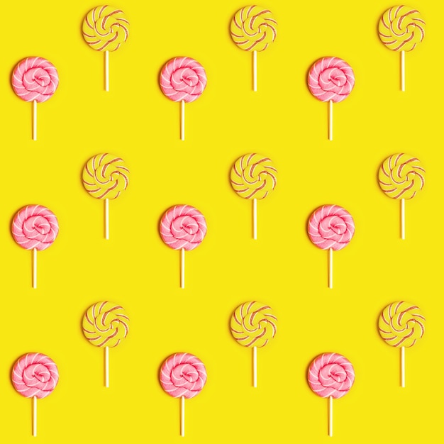 Seamless pattern with sweet round candy lollypops with stripes on stick