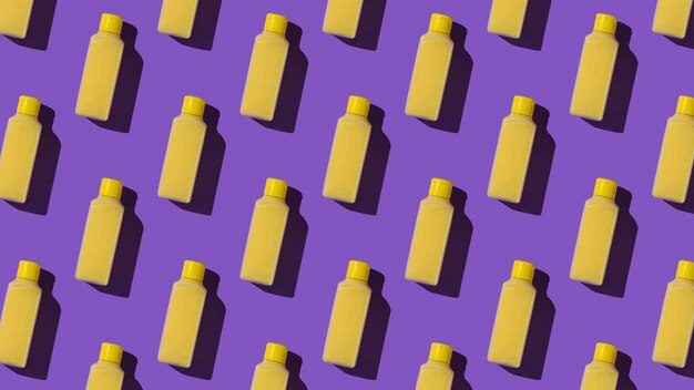 Seamless pattern of yellow plastic bottles. Cosmetic product in a plastic bottle.