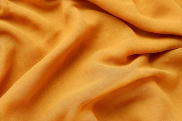 Seamless saffron yellow color fabric background texture with beautiful closeup detail fabric.